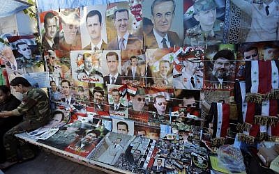 Pictures of President Bashar Assad, his late father and predecessor Hafez Assad, and Lebanese Hezbollah Leader Hassan Nasrallah are displayed at a street shop on May 11, 2014 in the capital Damascus. (photo credit: AFP/JOSEPH EID)