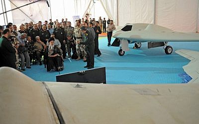 A photo released from the office of Iran's Supreme Leader Ayatollah Ali Khamenei on May 11, 2014 shows him (C-L) sitting next to the captured US RQ-170 sentinel high-altitude reconnaissance and its locally made copy at the Islamic Revolutionary Guard Corps Aerospace Force exhibition in Tehran.  (photo credit: AFP/HO/Iranian Leader's Website)