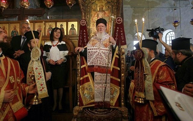 Ecumenical Patriarch of Constantinople Bartholomew I, center, prays at the Church of the Nativity, believed to be the birth place of Jesus Christ, on May 24, 2014 in the West Bank city of Bethlehem. (photo credit: AFP/ MUSA AL SHAER)