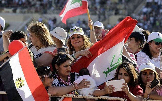 Iraqi Christians greet Pope Francis before a mass at the Amman stadium in the Jordanian capital on May 24, 2014. Pope Francis made an urgent plea today for peace in war-torn Syria as he kicked off a three-day pilgrimage to the Middle East. (Photo credit: AFP/Khalil Mazraawi) Iraqi Christians greet Pope Francis before a mass at the Amman stadium in the Jordanian capital on May 24, 2014. Pope Francis made an urgent plea today for peace in war-torn Syria as he kicked off a three-day pilgrimage to the Middle East. (Photo credit: AFP/Khalil Mazraawi)