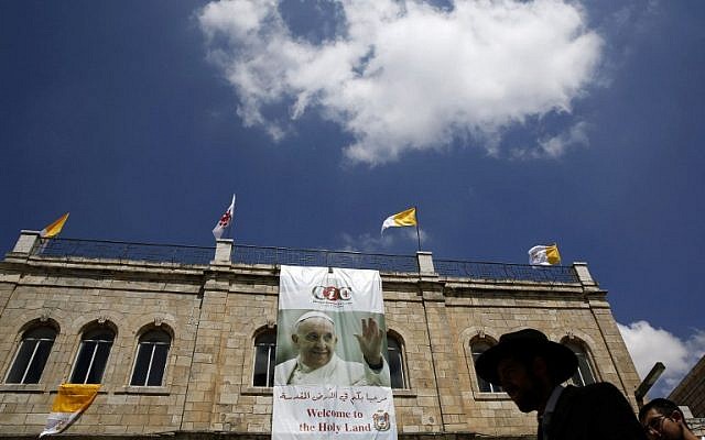 An ultra-Orthodox Jewish man walks past a large banner welcoming Pope Francis in Jerusalem's Old City Christian Quarter on Saturday, May 24, 2014 a day ahead of the top-level visit by Pope Francis to the Holy Land (photo credit: AFP/Gali Tibbon) An ultra-Orthodox Jewish man walks past a large banner welcoming Pope Francis in Jerusalem's Old City Christian Quarter on Saturday, May 24, 2014 a day ahead of the top-level visit by Pope Francis to the Holy Land (photo credit: AFP/Gali Tibbon)