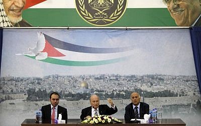 FIFA President Sepp Blatter sits between Prince Ali of Jordan (left), and Jibril Rajoub (right), who heads the Palestinian Football Federation, at the presidential headquarters in the West Bank city of Ramallah, on May 26, 2014. (photo credit: AFP/Abbas Momani)