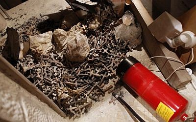 A picture taken on May 26, 2014, shows burnt wooden crosses and a fire extinguisher after arsonists set fire to a Catholic church at a contested site in Jerusalem during a visit by Pope Francis. (Photo credit: AFP / Thomas Coe)