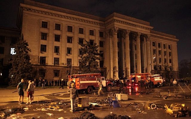 People watch as firefighters work at the burned Trade Union building late on May 2, 2014 in Odessa. More than 30 people were killed in a "criminal" blaze in Ukraine's southern city of Odessa, as violence spread across the country during the bloodiest day since Kiev's Western-backed government took power. (photo credit: AFP/STRINGER) People watch as firefighters work at the burned Trade Union building late on May 2, 2014 in Odessa. More than 30 people were killed in a "criminal" blaze in Ukraine's southern city of Odessa, as violence spread across the country during the bloodiest day since Kiev's Western-backed government took power. (photo credit: AFP/STRINGER)