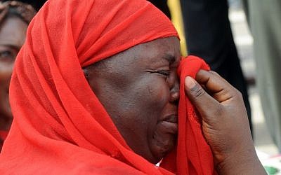 One of the mothers of the missing Chibok school girls wipes her tears as she cries during a rally by civil society groups pressing for the release of the girls in Abuja on May 6, 2014 (Photo credit: Pius Utomi Ekpei/AFP)