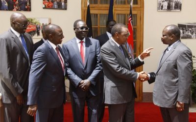 Kenya's President Uhuru Kenyatta (2ndR) shakes hands with South Sudan former secretary-general of the ruling party Pagan Amum (R), on May 8, 2014 in Nairobi, as South Sudan politicians were freed after their trial for treason was stopped in a move seen as a step towards ending brutal civil war. (photo credit: AFP/PSCU)
