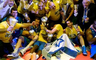 Maccabi Tel Aviv players celebrate their victory at the end of their Euroleague 2014 3rd place Final Four basketball game against Real Madrid, on May 18, 2014, at the Mediolanum stadium in Assago, Italy. (photo credit: Olivier Morin/AFP)