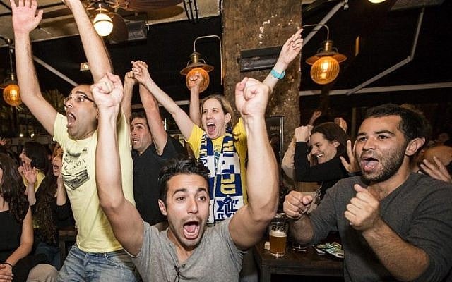 Maccabi Tel Aviv supporters watching the the Euroleague 2014 Final Four basketball match, Maccabi Tel Aviv vs Real Madrid, react to the victory of their team in a cafe on Kikar Rabin (Rabin Square) in Tel Aviv, May 18, 2014. (photo credit: Jack Guez/AFP) Maccabi Tel Aviv supporters watching the the Euroleague 2014 Final Four basketball match, Maccabi Tel Aviv vs Real Madrid, react to the victory of their team in a cafe on Kikar Rabin (Rabin Square) in Tel Aviv, May 18, 2014. (photo credit: Jack Guez/AFP)