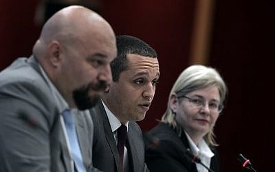 Golden Dawn far right party lawmaker Ilias Panagiotaros (L), party's spokesman and lawmaker Ilias Kasidiaris (C) and party's lawmaker and wife of jailed leader Eleni Zaroulia give a televised press conference in Athens ahead of the EU elections and the second round of local elections, in 2014 .(photo credit: AFP/Louisa Gouliamaki)