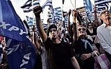A supporter of the Greek ultra-nationalist party Golden Dawn raises his fist during a preelection rally in Athens on May 23, 2014. (AFP/Aris Messinis)