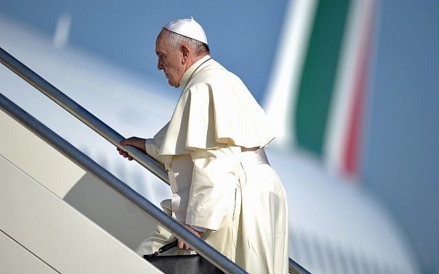 Pope Francis walks to the top of the stairs leading to his plane as he leaves Rome for the Middle East on Saturday, May 24, 2014. (photo credit: Filippo Monteforte/AFP)