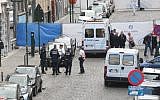 Policemen stand guard around the site of a shooting near the Jewish Museum in Brussels, on May 24, 2014. (AFP/Belga/Nicolas Maeterlinck)