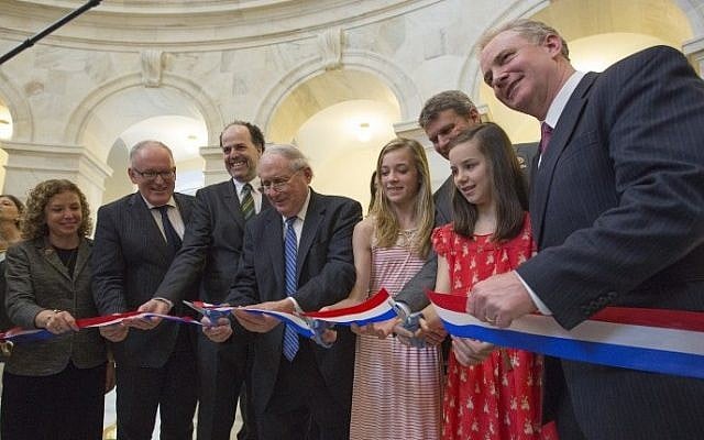 (L-R) US Representative Debbie Wasserman Schultz (D-FL), Dutch Foreign Minister Frans Timmermans, Executive Director of the Anne Frank House Ronald Leopold, Senator Carl Levin (D-MI), Sydney Huizenga, Representative Bill Huizenga (R-MI), Sydney Brown and Rep. Chris Van Hollen (D-MD) cut the ribbon at the opening of the Anne Frank exhibition on Capitol Hill, Washington, DC, April 30, 2014. (AFP Photo/Chris Kleponis)