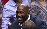 Magic Johnson attends game 4 of the NBA playoff series between the Los Angeles Clippers and the Oklahoma City Thunder, May 11, 2014, at the Staples Center in Los Angeles, California. (photo credit: AFP/ Robyn Beck)