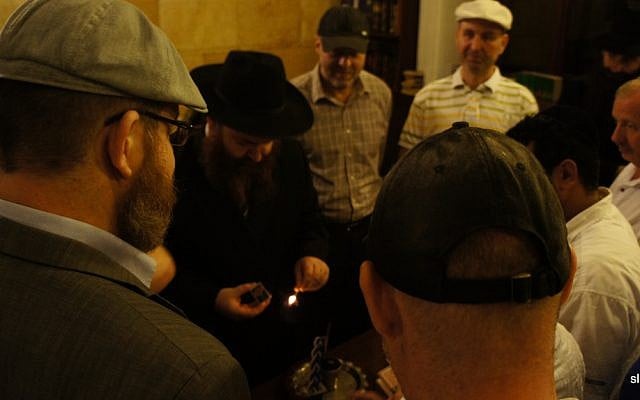 Jews participate in a Havdalah ceremony in a synagogue in Odessa, Ukraine, 2012. (photo credit: CC BY-Senia L/Flickr) Jews participate in a Havdalah ceremony in a synagogue in Odessa, Ukraine, 2012. (photo credit: CC BY-Senia L/Flickr)