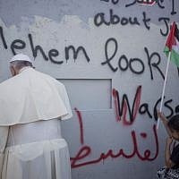Pope Francis stands at Israel's West Bank security barrier on his way to a mass in Manger Square in Bethlehem, May 25, 2014. (AP Photo/Ariel Schalit)