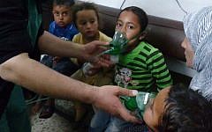 Illustrative photo: Children receive oxygen in Kfar Zeita, a rebel-held village in Hama province, Syria, after an alleged chemical attack, April 16, 2014. (AP Photo/Shaam News Network)