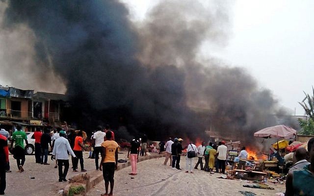 Smoke rises after a bomb blast at a bus terminal in Jos, Nigeria, on May 20, 2014. (photo credit: AP/Stefanos Foundation) Smoke rises after a bomb blast at a bus terminal in Jos, Nigeria, on May 20, 2014. (photo credit: AP/Stefanos Foundation)