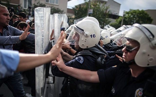 Riot police try to stop protesters attacking the offices of Prime Minister Recep Tayyip Erdogan's Justice and Development Party in Soma, Turkey, during the PM's visit on May 14, 2014. (photo credit: AP/Emrah Gurel) Riot police try to stop protesters attacking the offices of Prime Minister Recep Tayyip Erdogan's Justice and Development Party in Soma, Turkey, during the PM's visit on May 14, 2014. (photo credit: AP/Emrah Gurel)