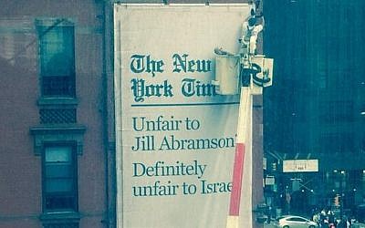 A sign plastered outside the New York Times' Times Square offices, accusing it of 'unfair' treatment of both former executive editor Jill Abramson -- and Israel. (photo credit: Twitter)