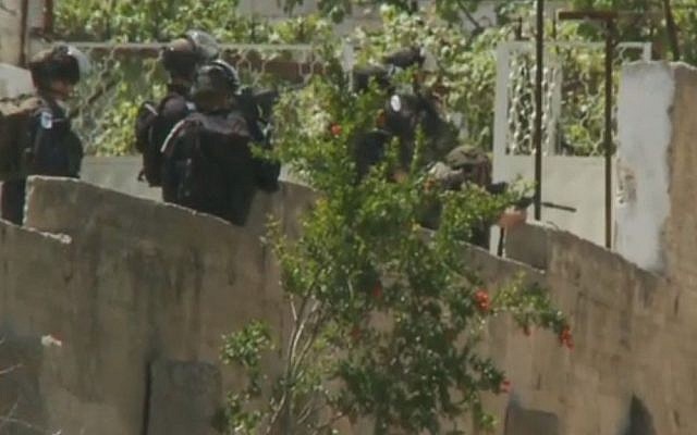 An IDF soldier is seen pointing his rifle at a group of Palestinians during a Nakba Day demonstration in the West Bank town of Bituniya on May 15. The soldier has been suspended from his unit and is under investigation. (screen capture: CNN) An IDF soldier is seen pointing his rifle at a group of Palestinians during a Nakba Day demonstration in the West Bank town of Bituniya on May 15. The soldier has been suspended from his unit and is under investigation. (screen capture: CNN)