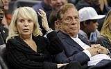 Los Angeles Clippers former owner Donald Sterling sits with his wife, Shelly, during the Clippers NBA basketball game against the Detroit Pistons in Los Angeles, in November 2010 (photo credit: AP/Mark J. Terrill, file)