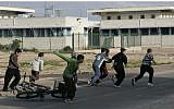 Illustrative: Israeli children run to a bomb shelter during a Color Red alarm warning of incoming rockets from the Gaza Strip, January 8, 2009. (Anna Kaplan/ Flash90/File)