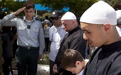 A Druze family stands silent during a Memorial Day ceremony at the military cemetery of Ussefiya on Mount Carmel, April 2010 (photo credit: Matanya Tausig/Flash90)