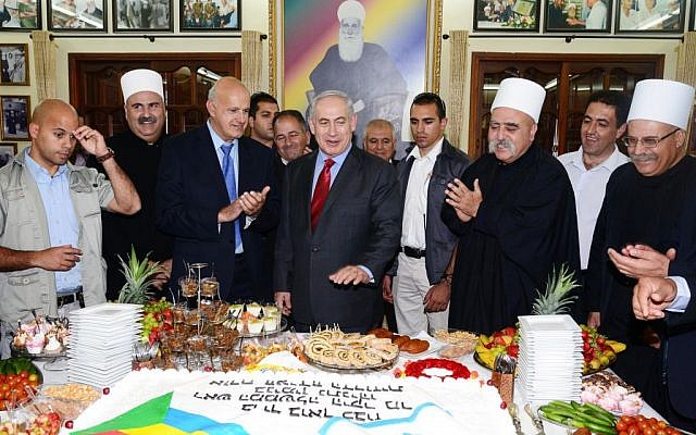 Israeli Prime Minister Benjamin Netanyahu meets with the Spiritual Leader of the Druze Community in Israel Sheikh Muwaffaq Tarif (2R) in the village of Julis in Northern Israel, April 25, 2013 (photo credit: Moshe Milner/GPO/FLASH90)
