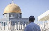 An Orthodox Jew stands facing the Dome of the Rock on the Temple Mount in the Old City of Jerusalem on July 24, 2013. (Lucie March/Flash90)