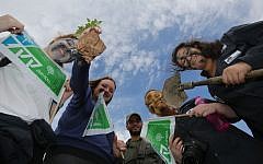 Israelis holding Jewish National Fund signs in the West Bank settlement of Michmash in January 2014 (Yossi Zamir/Flash 90)