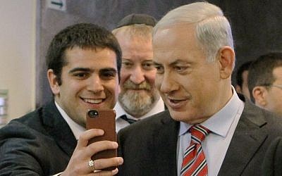 A student takes a 'selfie' with Prime Minister, Benjamin Netanyahu, March 30, 2014 (photo credit: Danny Meron/POOL/Flash90)