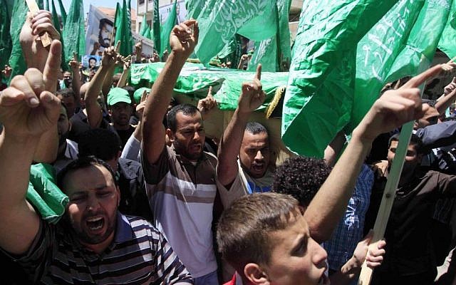 Palestinian mourners wave the green flag of the Islamist movement Hamas at a funeral on April 30, 2014, in the West Bank city of Ramallah. (photo credit: Issam Rimawi/Flash90) Palestinian mourners wave the green flag of the Islamist movement Hamas at a funeral on April 30, 2014, in the West Bank city of Ramallah. (photo credit: Issam Rimawi/Flash90)