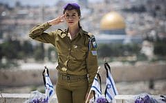 An Israeli soldier salutes fallen soldiers during a ceremony held on the Mount of Olives in preparation for Memorial Day, May 4, 2014. (photo credit: Yonatan Sindel/Flash90)