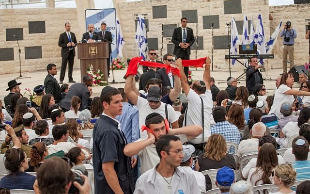 Protesters angry at Israel's decision to release Palestinian prisoners as part of US-mediated peace talks interrupt the speech of Israeli Prime Minister Benjamin Netanyahu at a ceremony held at Mount Herzl military cemetery in Jerusalem on May 05, 2014. (Photo credit: Emil Salman/Pool/Flash90) Protesters angry at Israel's decision to release Palestinian prisoners as part of US-mediated peace talks interrupt the speech of Israeli Prime Minister Benjamin Netanyahu at a ceremony held at Mount Herzl military cemetery in Jerusalem on May 05, 2014. (Photo credit: Emil Salman/Pool/Flash90)