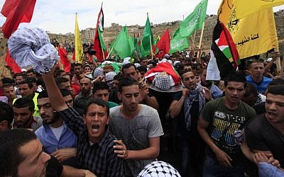 Palestinians mourn the deaths of two Palestinian teens, shot by the IDF, at their joint funeral in the West Bank town of Birzeit, north of Ramallah, on May 16, 2014. (photo credit: Issam Rimawi/Flash90)