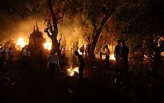 Ultra-Orthodox Jews gather around the bonfire during celebrations of the Jewish holiday of Lag B'Omer in the ultra-Orthodox city of Bnei Brak, outside of Tel Aviv, on May 17, 2014. (photo credit: Yaakov Naumi/Flash90)