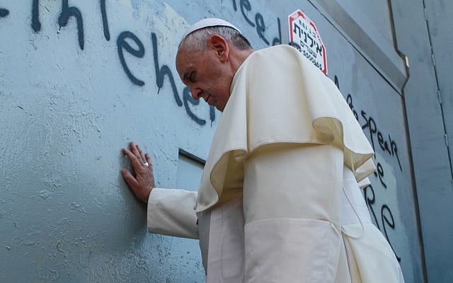 Pope Francis prays against the security barrier at Bethlehem, May 25, 2014 (photo credit: Nour Shamaly/Flash90)