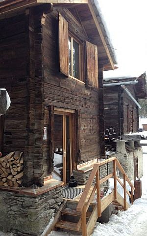 The log cabins date back to earlier times in Saas Fee, once used to store crops, and are slowly being restored, like this one that is being used as a fondue cafe (photo credit: Jessica Steinberg/Times of Israel)
