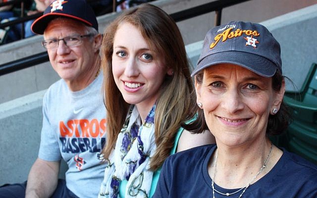 Karen Zeid, right, with husband Ira and daughter Emily at the Astros game against the Orioles in Baltimore on May 11, 2014, has chronicled her son's roller-coaster baseball journey with a journal. (Hillel Kuttler/JTA)