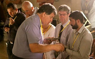 Vicar Pileggi giving communion to participants in the conference (photo credit: Carino Casas/ Christ Church Jerusalem)