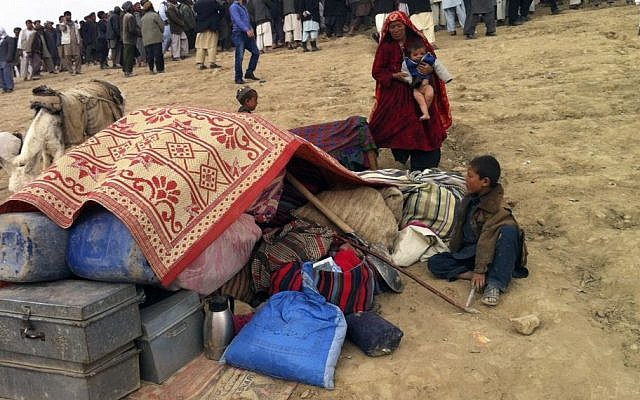 Survivors sit with their possessions near the site of Friday's landslide that buried Abi-Barik village in Badakhshan province, northeastern Afghanistan, Saturday, May 3, 2014. (Photo credit: AP/Amir Shah) Survivors sit with their possessions near the site of Friday's landslide that buried Abi-Barik village in Badakhshan province, northeastern Afghanistan, Saturday, May 3, 2014. (Photo credit: AP/Amir Shah)