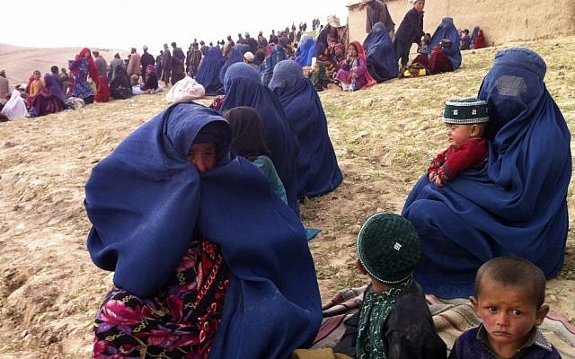 Survivors sit on a hillside as others watch the rescue effort near the site of Friday's landslide that buried Abi-Barik village in Badakhshan province, northeastern Afghanistan, Saturday, May 3, 2014. (Photo credit: AP/Amir Shah) Survivors sit on a hillside as others watch the rescue effort near the site of Friday's landslide that buried Abi-Barik village in Badakhshan province, northeastern Afghanistan, Saturday, May 3, 2014. (Photo credit: AP/Amir Shah)