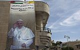 In this photo taken Monday, May 19, 2014, a welcome banner for Pope Francis with his picture hangs on a building in the West Bank city of Bethlehem. (photo credit: AP/Nasser Nasser)