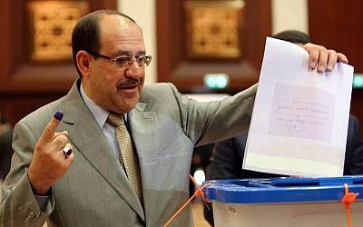 Iraqi Prime Minister Nouri al-Maliki prepares to cast his vote at a polling station in the heavily fortified Green Zone in Baghdad, Iraq, on Wednesday, April 30, 2014. (photo credit: AP Photo)