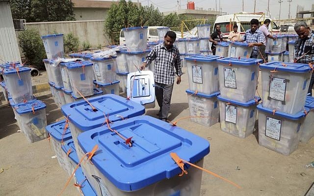 Electoral workers carry ballot boxes at a counting center in Basra, Iraq's second-largest city, May 1, 2014 (photo credit: AP/Nabil Al-Jurani) Electoral workers carry ballot boxes at a counting center in Basra, Iraq's second-largest city, May 1, 2014 (photo credit: AP/Nabil Al-Jurani)