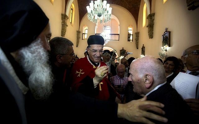 Cardinal Bechara Rai, head of the Maronite Catholic Church, center, visits a church in Jaffa, a mixed Jewish and Arab neighborhood in Tel Aviv, Israel, Monday, May 26, 2014.  (photo credit: AP Photo/Sebastian Scheiner)