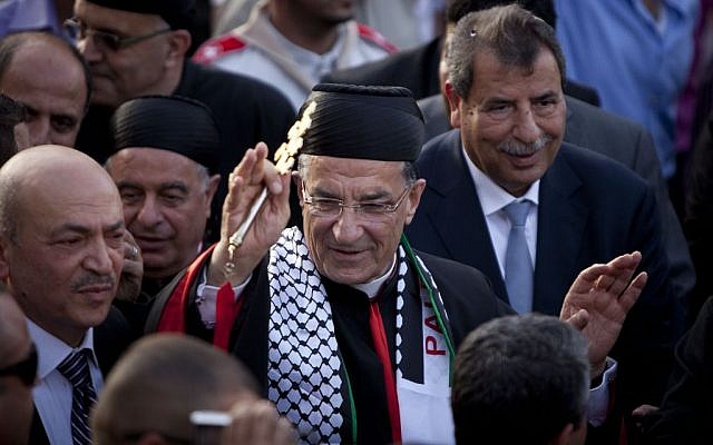 Cardinal Bechara Rai, the first leader of Lebanon's largest Christian sect, the Maronite Catholic Church to visit Jerusalem since Israel captured the city's eastern sector, arrives to attend a mass in the West Bank town of Beit Sahour, near Bethlehem, Tuesday, May 27, 2014. (photo credit: AP Photo/Majdi Mohammed)