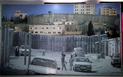 In this photo taken Tuesday, May 20, 2014, a poster decorates the main hall that will receive Pope Francis during his upcoming visit to the Holly Land this weekend, at the Phoenix center in the Dheisheh Palestinian refugee camp, in the West Bank city of Bethlehem. (photo credit: AP Photo/Nasser Nasser)