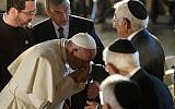 Pope Francis kisses the hand of a Jewish man at the Hall of Remembrance during his visit to the Yad Vashem Holocaust Memorial museum in Jerusalem Monday, May 26, 2014. (photo credit: AP /L'Osservatore Romano)